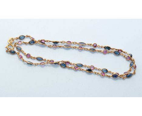 A ruby and sapphire necklace, alternately set with circular facet cut rubies and marquise cut sapphires, mounted in 9ct. yell
