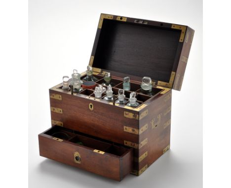 A 19th Century brass bound mahogany apothecary box, the hinged top opening to reveal glass jars, underlying drawers fitted sc