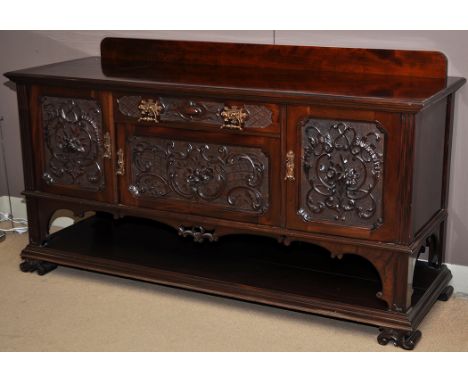 A good quality Victorian carved sideboard, fitted centre frieze drawer and cupboard, flanked either side by carved cupboard d