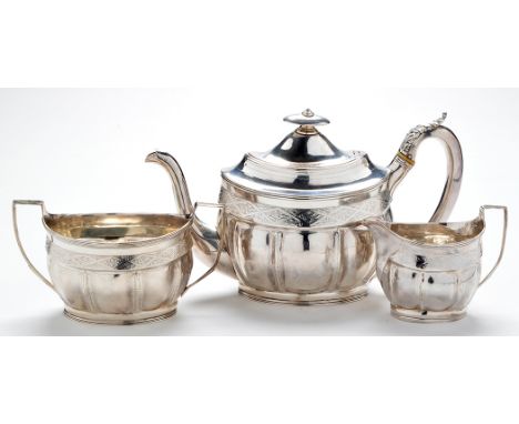 A George III three-piece tea service, by Peter & William Bateman, London 1805, of shaped oval form with engraved foliate band