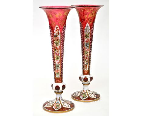 Pair of pale ruby and opaque glass slender vases, the faceted sides painted with wild flowers above knop stems and flattened 