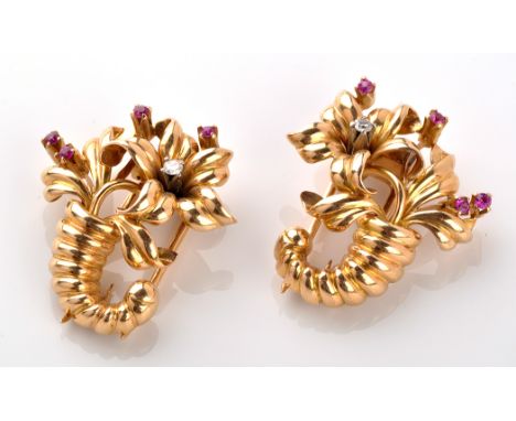 A pair of diamond and ruby set cornucopia pattern fur clips, each with fluted horn holding a flower set with single brilliant