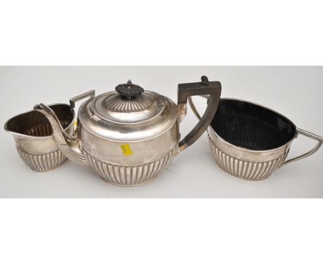 A late Victorian three-piece tea service, by Walker & Hall, Sheffield 1900, of oval half fluted form, engraved inscription, t
