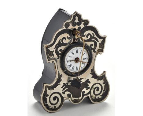 A miniature white metal and wooden mantel clock, in the French taste with enamelled roman dial and ornate foliate surround, w