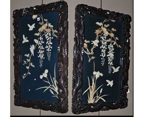 A pair of late 19th Century Japanese carved wood and ivory inlaid Shibayama wall panels, each panel decorated with birds and 