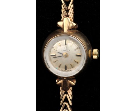 Omega: a 1960's ladies 9ct. gold bracelet watch, with circular baton dial and thin flexible strap.