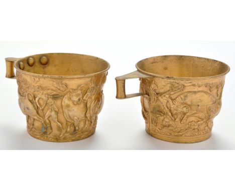 A pair of late 19th Century giltmetal replica Vaphio cups, depicting scenes with bulls, each 3in. (8cms) high.

NB
The Vaphio