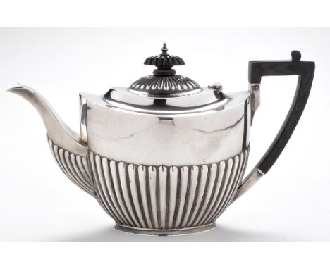 An Edwardian teapot, by J. Deakin & Sons, Sheffield 1905, oval half fluted, ebonised finial and angular handle, 6in. (15cms),