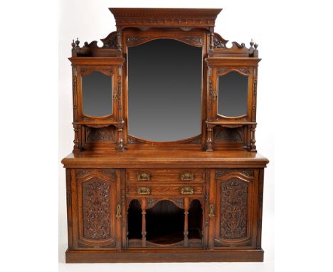 A Victorian oak sideboard, the mirror panel back flanked by glazed cupboard doors, the base fitted two central drawers above 