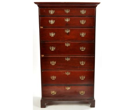 A late George III mahogany chest of seven long graduated drawers, each fitted replacement pierced brass escutcheons and handl