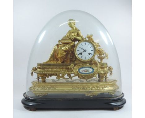 A French gilt metal cased figural mantel clock, inset with a Sevres style porcelain panel, surmounted by a classical figure h