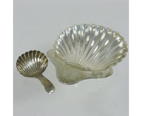 A George III silver shell caddy spoon, with bright cut decoration, London 1786, together with a Victorian shell shaped butter