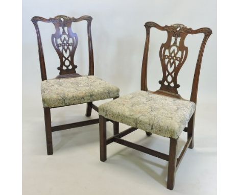 A pair of George III carved mahogany side chairs, each of large proportions, of Chippendale design, on square legs