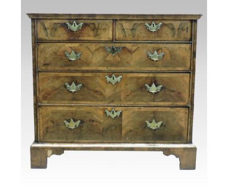An 18th century walnut, crossbanded and featherbanded chest, containing two short over three long drawers, on bracket feet, 9