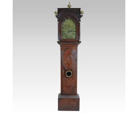 An 18th century walnut cased longcase clock, the door centred by a lenticle, having an arched brass dial with subsidiary seco