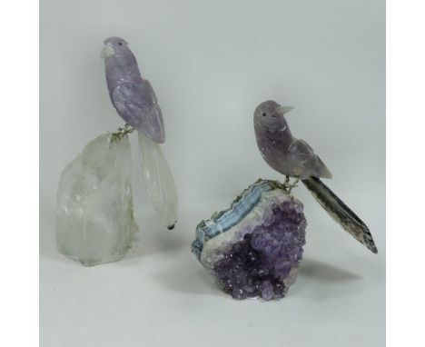 A Brazilian hardstone model of a parrot, naturalistically modelled, with metal legs, perched on a rock crystal base, 21cm tal