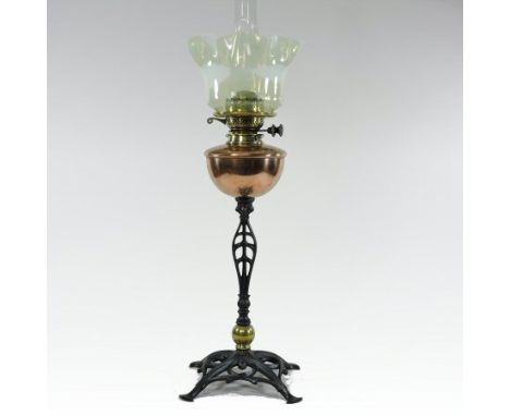 An Arts and Crafts wrought iron brass and copper oil lamp, by W.A.S. Benson, with a frilled opaline glass shade, copper reser