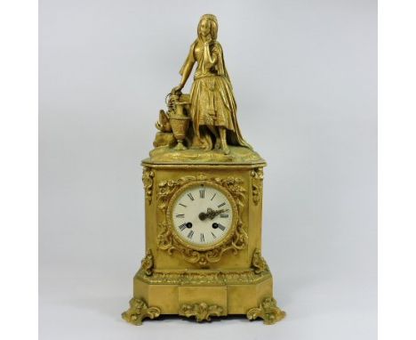 A 19th century French ormolu cased mantel clock, decorated with scrolls and acanthus and surmounted by a young lady, the eigh