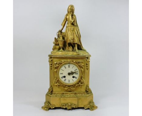 A 19th century French ormolu cased mantel clock, decorated with scrolls and acanthus and surmounted by a young lady, the eigh