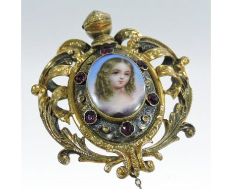 An ornate 19th century unmarked gem set brooch, inset with a portrait of a young girl, on ivory, within a ribbon and scroll s