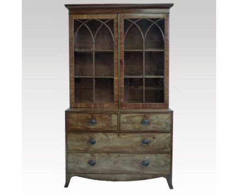 A 19th century mahogany bookcase on chest, the upper section enclosed by lancet glazed doors, the base containing two short o