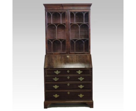 A late 19th century mahogany bureau bookcase, the bookcase top enclosed by a pair of astragal glazed doors, the base with a y