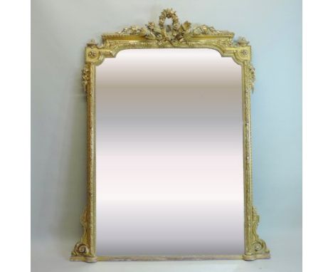 A large 19th century carved pine and gilt gesso framed wall mirror, the shaped rectangular plate, within a moulded surround, 