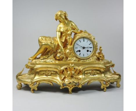 A French ormolu figural mantel clock, the ornate scrolled case, surmounted by a figure of reclining water carrier, the white 