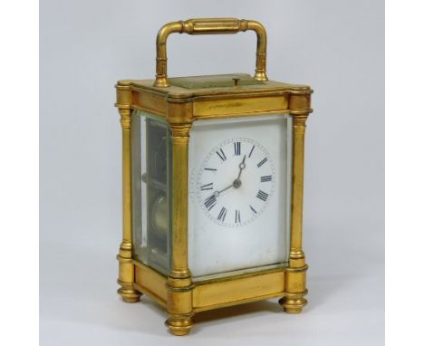 An early 20th century gilt brass cased carriage clock, with a white enamel dial, the lever platform escapement, with a push r
