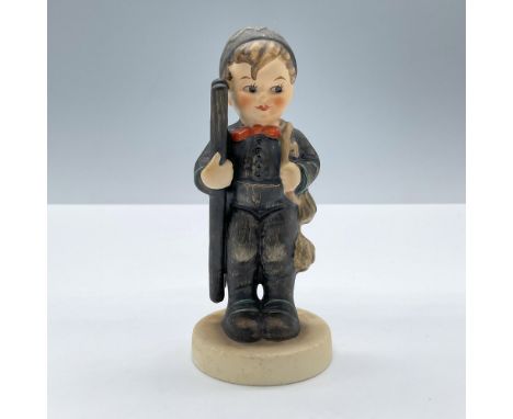 Features a little boy modeled in a black uniform and ladder. Goebel Hummel backstamp. Issued: 20th centuryDimensions: 4''H x 
