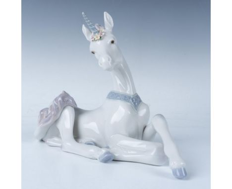 Glossy finish. Features a white unicorn with purple accents, laying down on the floor with flowers around its horn. Lladro ba