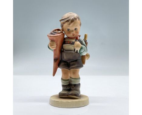 Features a young boy on his first day of school fashioned in a lederhosen carrying a backpack and a traditional German school