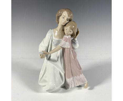 Beautiful glazed porcelain depiction of a mother and daughter in their night dresses. Both have short, light brown hair. Moth