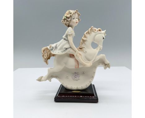 Fine crafted resin with white matte finish captures a young girl riding a detailed rocking horse. Marked made in Italy. Impre