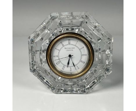 Exquisite clear crystal table clock featuring a gilt rim and black roman numerals. Waterford mark on the back. Dimensions: 5"