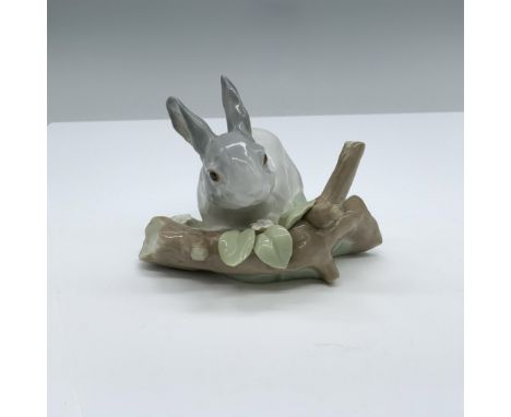 Glossy finish. Features a gray rabbit in a branch. Lladro backstamp. This item has its original box. 8"L x 5.25"W x 5"H. Arti