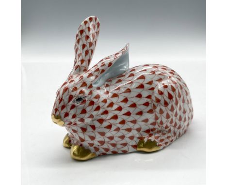 Hand painted rust over white porcelain with gilt accents on nose and paws with a solid rust colored tail. Inner ears are a li