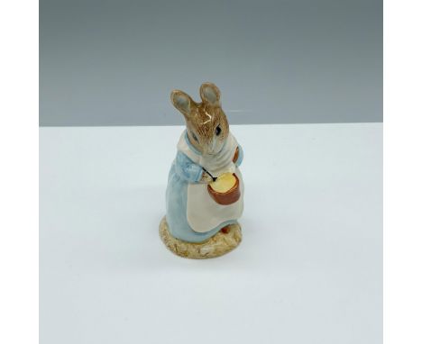 Glossy porcelain figure holding a pot and stirring with a spoon. Royal Albert Beatrix Potter backstamp. This item has its ori