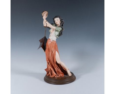 Fine crafted resin features a graceful woman holding a tambourine. Marked G. Armani. Marked made in Italy. Marked Capodimonte