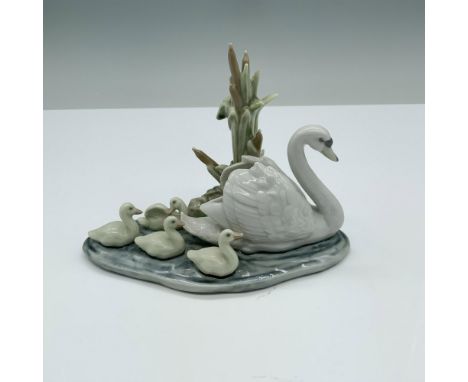 Glossy finish. Features a elegant swan swimming with her babies behind. Lladro backstamp. This item has its original box. Box