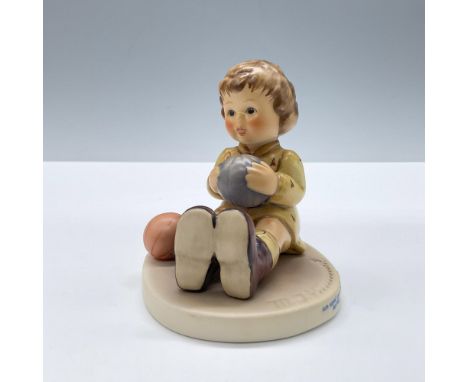 Exclusive edition for the M.I Hummel Club. Features a child sitting, dressed in yellow clothes and toy balls. Goebel backstam