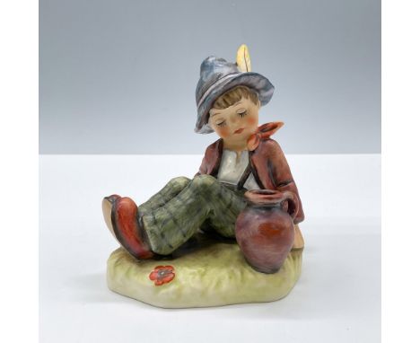 Features an adorable boy sitting, models a red-brown jacket and green trousers. Goebel Hummel backstamp. Issued: 20th century