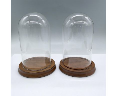 Two display glass domes with light mahogany tinted wooden bases. They each measure 7.5"H x 5.25"dia. Issued: 21st centuryDime