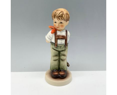 Stunning figure depicting a young boy in overalls holding a bow behind his back. Goebel backstamp. Certificate of Authenticit