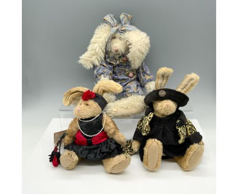 Darling trio of rabbits that consists of a fluffy bunny in a onesie with a bow in her hair, a fancy bunny in a red and black 