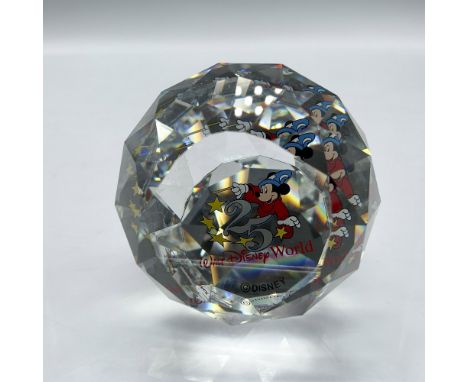 Clear faceted crystal decorated with Mickey the Sorcerer waving his wand. Swarovski mark. This item has its original box: 4"L