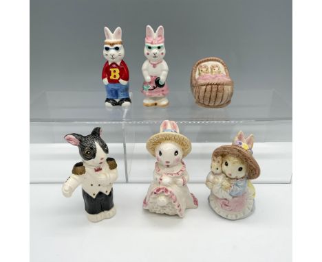 Darling assortment of differently styled rabbits that includes a rabbit in a white suit, a rabbit in a pink and white dress, 