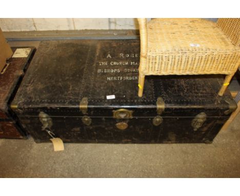 A large brass bound travelling trunk with name and address to lid