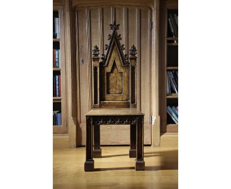 A PAIR OF WILLIAM IV OAK GOTHIC REVIVAL HALL CHAIRSIN THE MANNER OF A.W.N. PUGIN, C.1830each with a pinnacle back with scroll