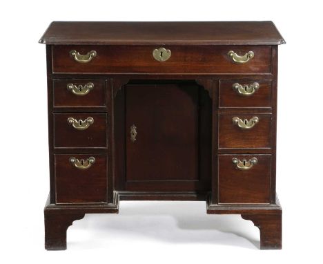 A GEORGE II MAHOGANY KNEEHOLE DESKC.1750-60the caddy moulded edge top with re-entrant front corners, above an arrangement of 